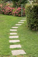 Block paving used as a stepping stone path through lawn
