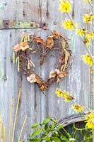 Willow heart wreath decorated with dried Hydrangea flowers and Betula - Birch catkins. 