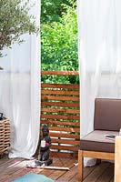 View of Mediterranean summer balcony,  White curtains as Sun protection 