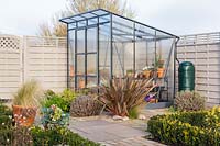 View of small greenhouse in modern garden.