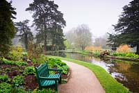 The Wells Garden where the springs which give the town its name emerge from the ground to create tranquil pools surrounded by lush planting at the Bishop's Palace Garden, Wells, Somerset