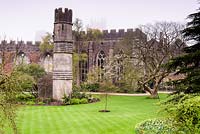 Shrubs and trees surround the ruins of the Great Hall in the South Garden at the Bishop's Palace Garden, Wells, Somerset, UK