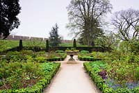 The East Garden, a formal space with low Euonymus hedging, roses and herbaceous planting at Bishop's Palace Garden, Wells, Somerset, UK.