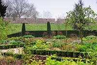 The East Garden, a formal space with low euonymus hedging, roses and herbaceous planting at Bishop's Palace Garden, Wells, Somerset UK
