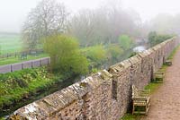 View over the ramparts to the moat surrounding the Bishop's Palace Garden, Wells, Somerset, UK. 