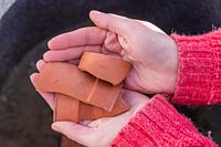 Handful of broken terracotta crocks, used to aid drainage at the bottom of pots.