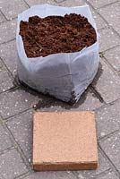 Compressed coconut fibre compost - Compressed in packet and after adding water.