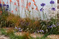 Stepping stones surrounded by mixed perennial planting. 'High Tide 2030 Garden 2030' - RHS Tatton Park Flower Show, 2016. 