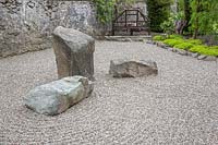 Walled Japanese garden, with 'Sea' of raked gravel with stone monoliths. 
