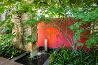 Contemporary water feature in shady tropical garden. Von Phister Residence, Key West, Florida, USA. Garden design by Craig Reynolds.
