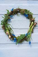 Mossed wreath decoration with ferns and flowering Muscari.
