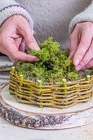 Woman adding moss to the nest