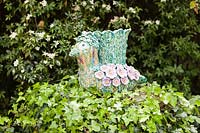 Bird Urn - ceramic artwork - placed on a stump covered in Helix hedera - Ivy
