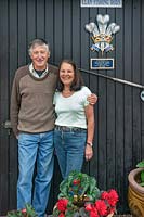 Couple standing outside his fishing rod business with official 
'By Appointment to HRH Prince Charles' Royal Crest