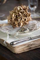 Dried Hydrangea place setting on vintage book charger