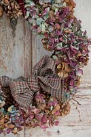 Multicoloured dried Hydrangea wreath with tartan bow