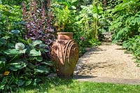 Decorative terracotta pot in garden