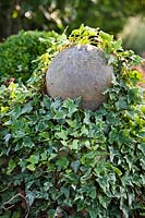 Sphere on pedestal covered with Hedera helix - Ivy. 