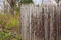 Fence made with wooden stakes called a palisade, Montreal Botanical Garden, Quebec, Canada. 