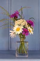 Vase with Ox-eye daisies, lesser knapweed and grasses