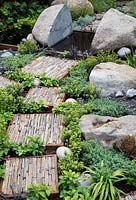Rough stepping stones in the Through Your Eyes garden, designed by Lawerence Roberts and William Roobrouck, sponsored by Kebony, CED Stone Group, RandG Metal Products at RHS Hampton Court Garden Festival, 2019.