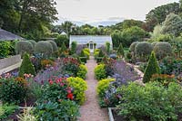 A fully restored Victorian walled kitchen garden is planted with a mix of annual flowers, herbs, fruits and vegetables. 