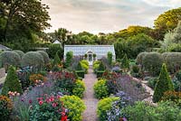 A fully restored Victorian walled kitchen garden is planted with a mix of topiary, annual flowers, herbs, fruits and vegetables.