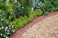 Gravel path with brick edging in The Baroque garden at RHS Tatton Park Flower Show, 2019. 