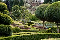View across Knot garden and topiary forms at Abbey House Gardens, Malmesbury, UK. 