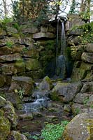 Waterfalls spill over rockery, at Abbey House Gardens, Malmesbury, UK. 