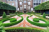 Formal clipped topiary and pleached limes in the garden of the Museum Willet-Holthuysen. Amsterdam, The Netherlands. The garden is maintained by garden designer Saskia Albrecht, in collaboration with the Museum Paleis Het Loo.