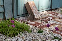 Detail of stencilled brick path set in grave gardenl, with Armeria maritima and Chamomile growing amongst stones. 