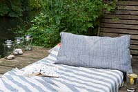 Mattress and pillow on wooden decked area 