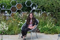 Caitlin McLaughlin has designed a garden that focuses on plants to encourage pollinators - A wall made from honeycomb shapes contains twigs to encourage solitary bees.
