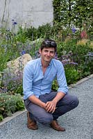Garden designer Will Williams beside one of the wildlife-friendly borders in a contemporary garden 