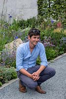 Garden designer Will Williams beside one of the wildlife-friendly borders in a contemporary garden