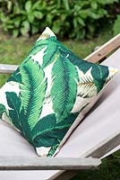 Cushion with jungle leaf print 