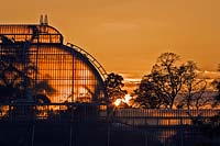 Sunset behind the palm house at Kew Botanic Gardens, Kew, Richmond, UK. 