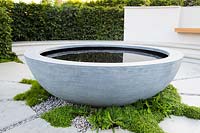 Concrete round water feature. The South West Water Green Garden at RHS Hampton Court Palace Flower Show 2018 