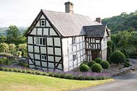 View of Hurdley Hall and gardens overlooking surrounding countryside in Powys, Wales, UK. 