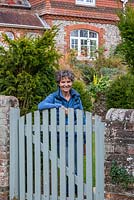 Jackie Sherling at the gate of her flint and brick cottage.
