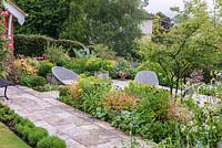 Purbeck stone terrace with spring borders 