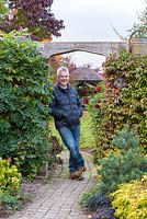 Ray Blundell standing in the archway leading into his garden.