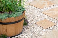 Wooden barrel with herbs on a patio with white gravel and paving - Ikhaya: Home - Green Living Spaces, RHS Malvern Spring Festival 2019
