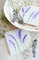 Handmade salt dough tiles with lavender design in a basket.