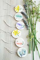 Gift tags made of salt dough and painted pressed flower impressions
