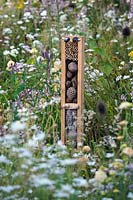Insect friendly timber post in wild garden. RHS Hampton Court Festival 2019.