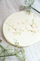 A circle of salt dough with imprints left after removal of flower stems
