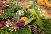 A selection of foliage, berries and dried fruit ready to make Christmas decorations