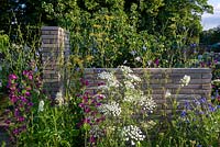 Belgian paver brick partitions providing backdrop to Ammi majus, Cornflower and Malva - The RHS Sanctuary Garden, RHS Hampton Court Palace Flower Festival 2019